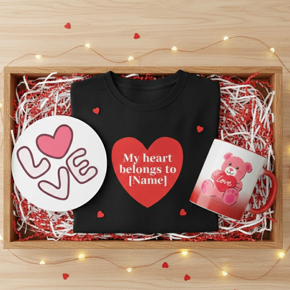 Black sweatshirt with a heart design, mug, and plate in a decorative box with lights.