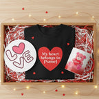 Black sweatshirt with a heart design, mug, and plate in a decorative box with lights.