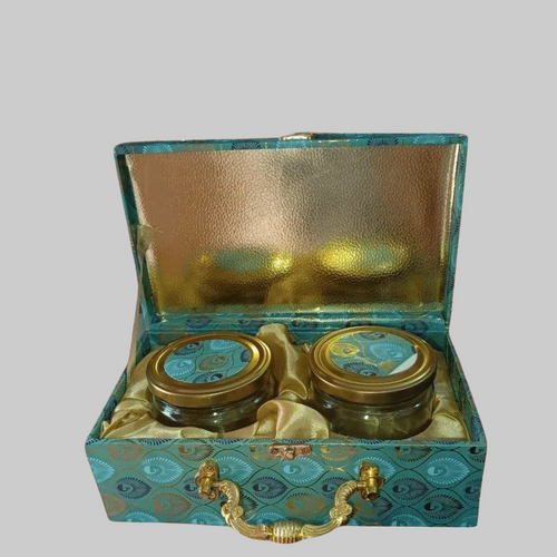 Two jars in a decorative box with fireworks in the background