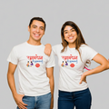 Two people wearing white t-shirts with text and a rakhi on a colorful background