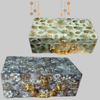Decorative boxes with intricate patterns and gold accents on a purple background.